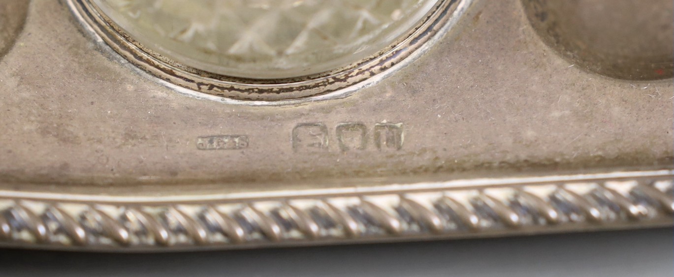 A late Victorian silver rectangular inkstand, with two wells and central lidded compartment, (glass well missing), on claw and ball feet, John Grinsell & Sons, London, 1895, 20.4cm, 12.9oz.